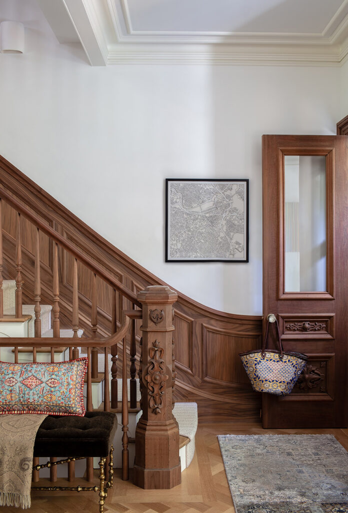 Interior by Adams + Beasley - view of an entryway with a carved staircase