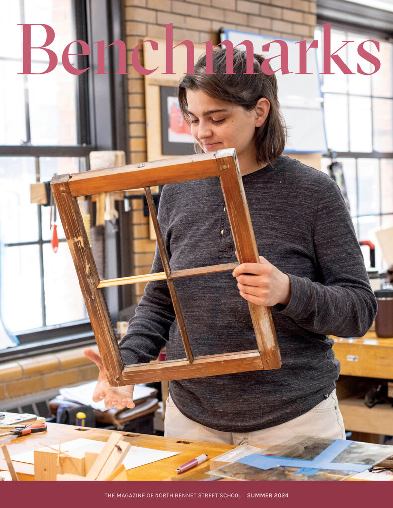 Cover of Benchmarks magazine showing a student holding a window frame