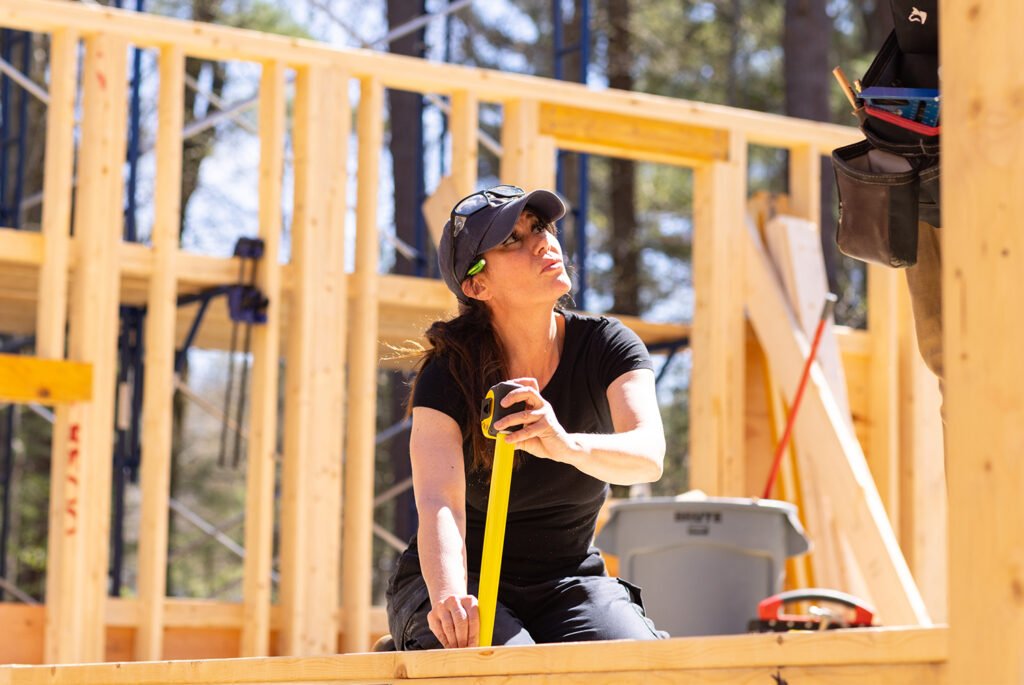 Carpentry student using measuring tape