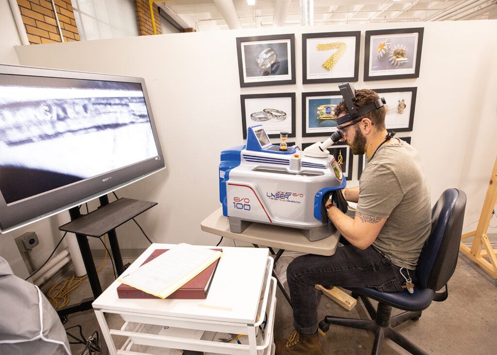 Zachary Westelman using a laser welder in the Jewelry Making & Repair program