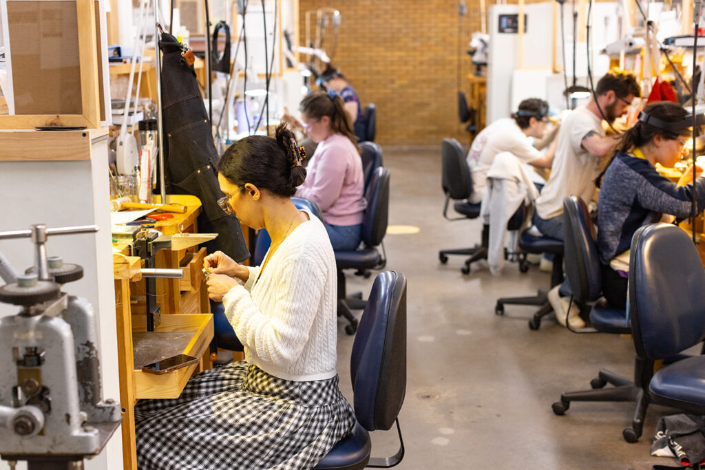 Jewelry making students working at their benches