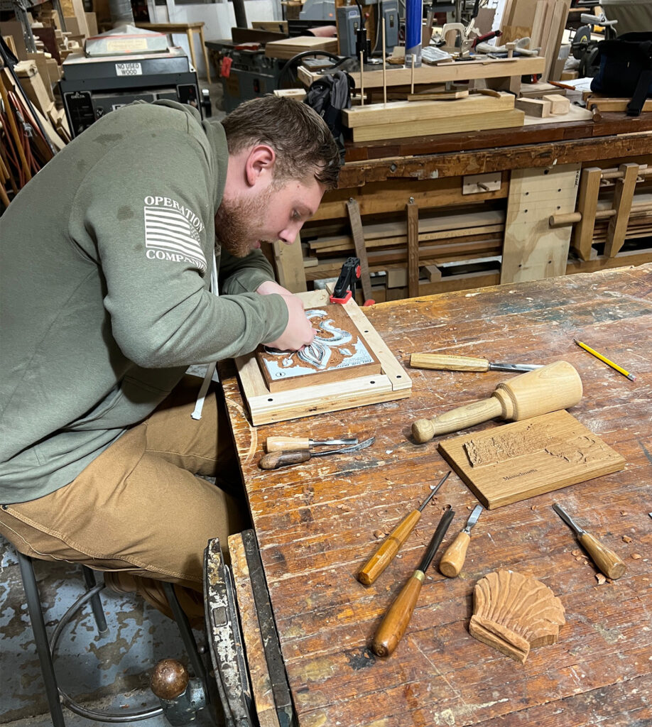 One of Mark DeVeber's students carving at the Wood Hobby Shop at the Portsmouth Naval Shipyard