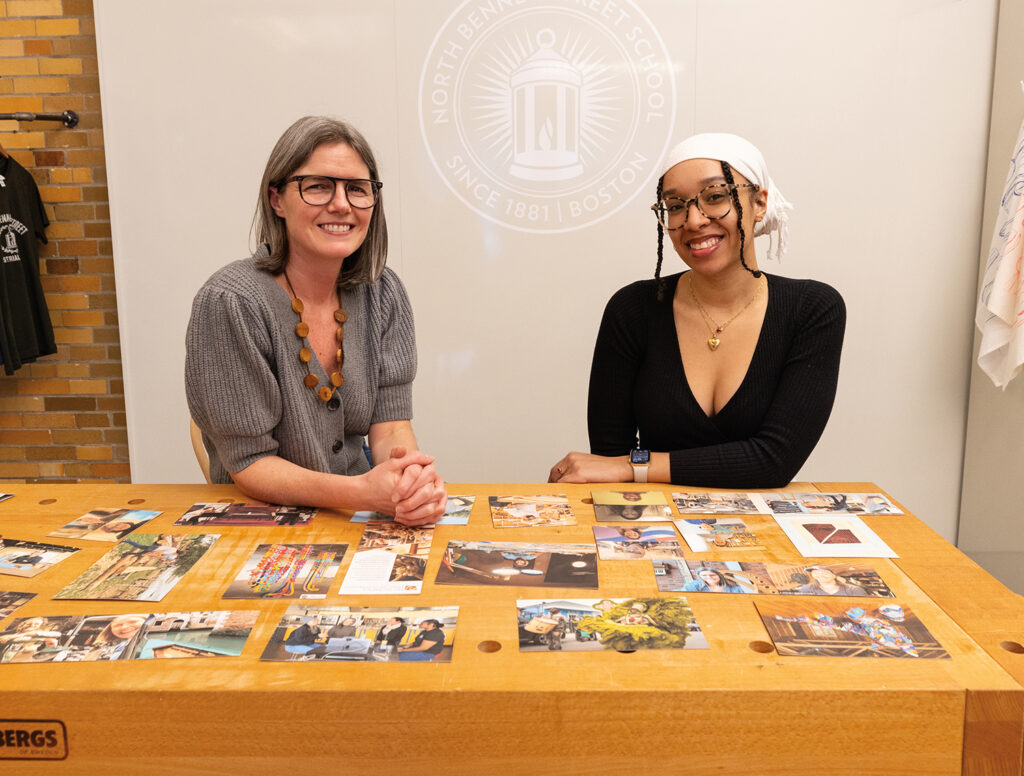 Kristen and Ja'Hari organizing photos for the exhibition