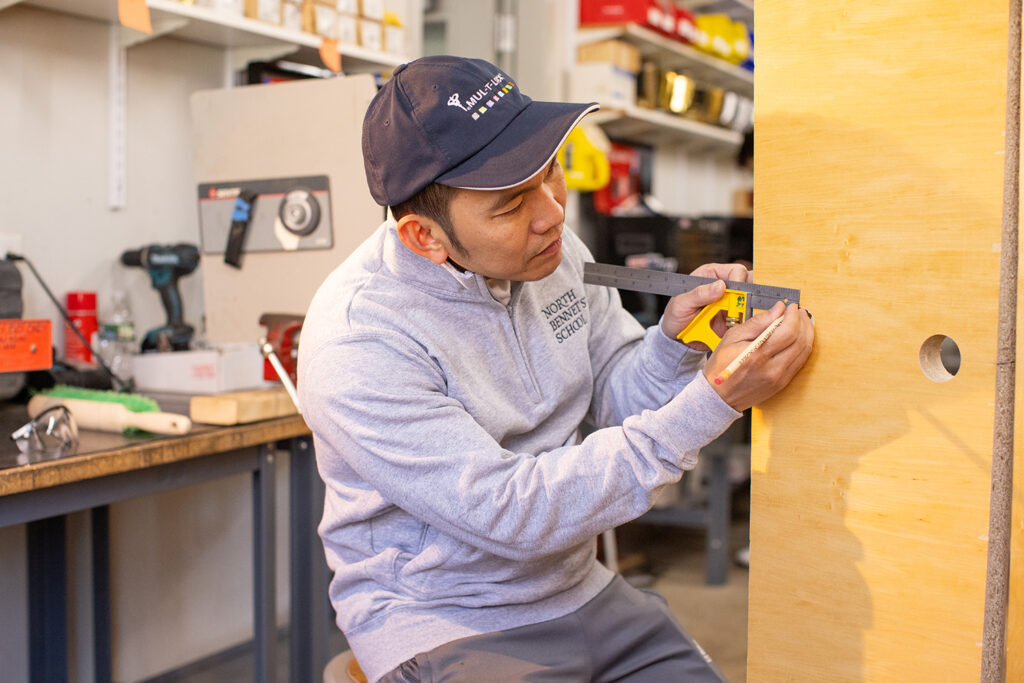 Andy measuring a door blank to install hardware