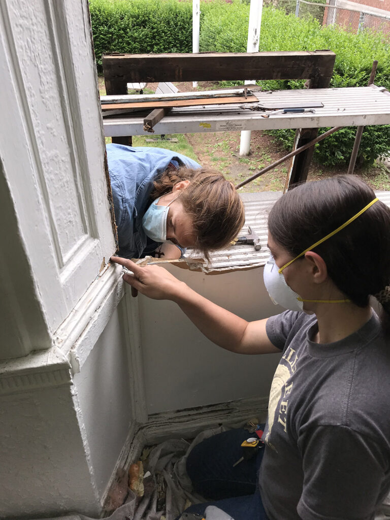 Second-year students Sophie and Charlotte inspecting the interior windows in spring 2021