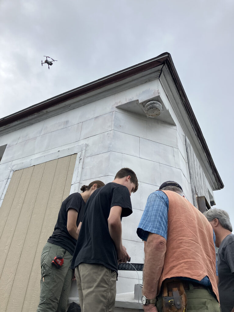 Students and faculty inspecting where the columns of the belvedere on the roof were removed in spring 2024