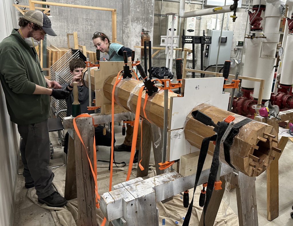 Second-year students building a staved new column