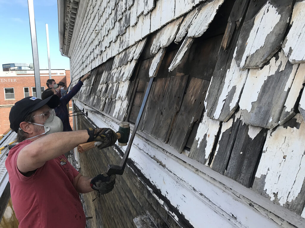 Removing old shingles in June 2021. Photo by then-student Sophie Linnell PC ’21.