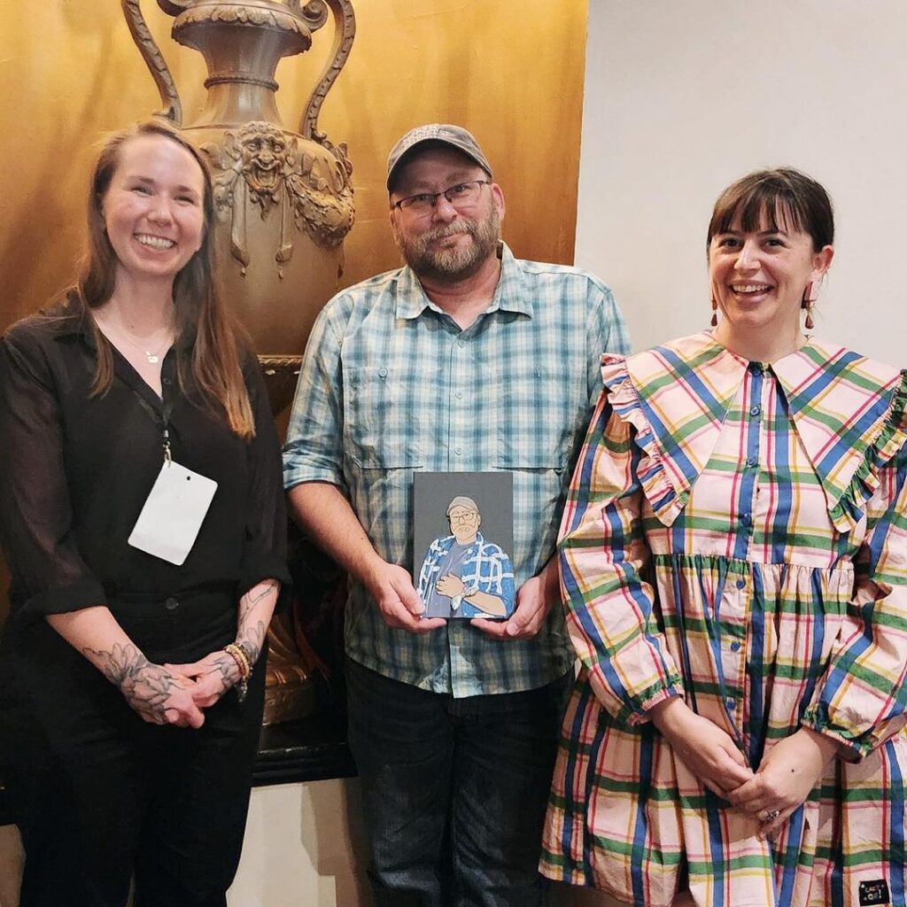 Gabby Cooksey and Erin Fletcher BB ’12 presenting a Guild of Book Workers award they made to Jeff Altepeter in 2024