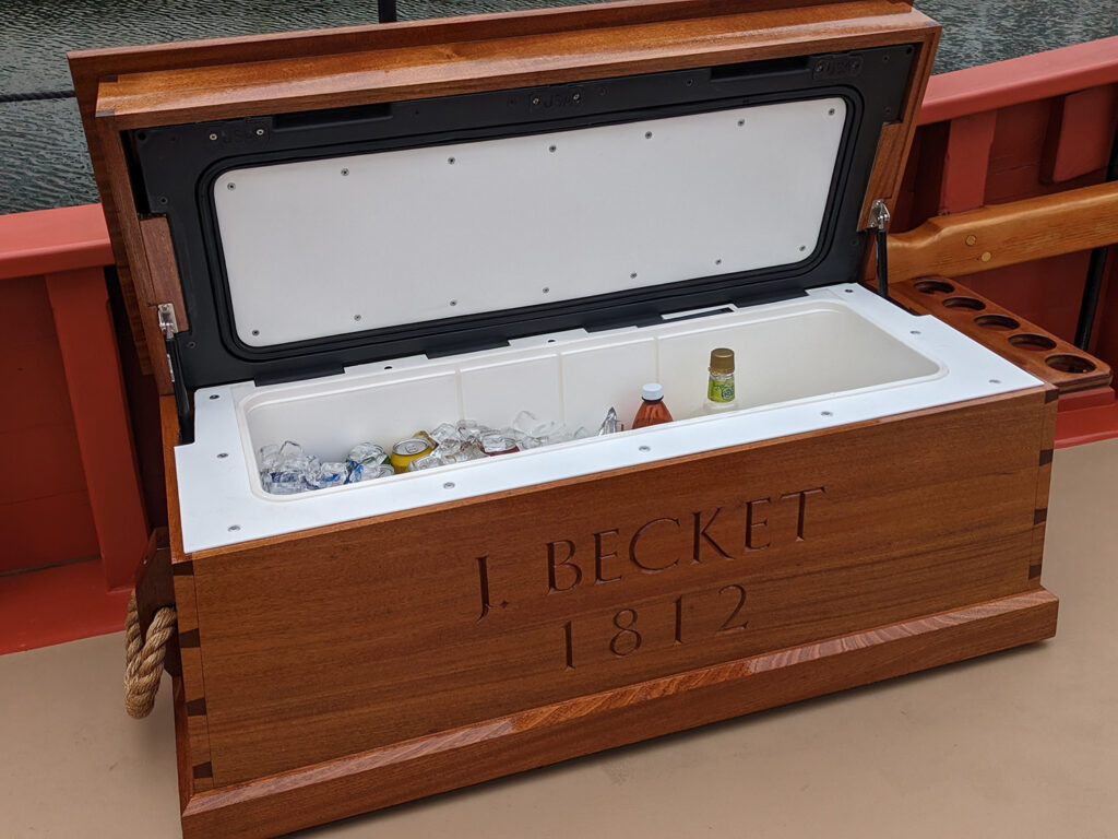 Completed chest for L. Becket on deck of The Fame, with the lid open showing drinks in ice