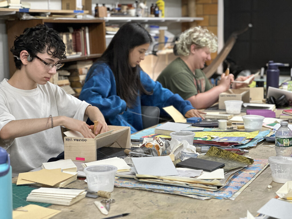 Bookbinding Teen Intensive student sewing books
