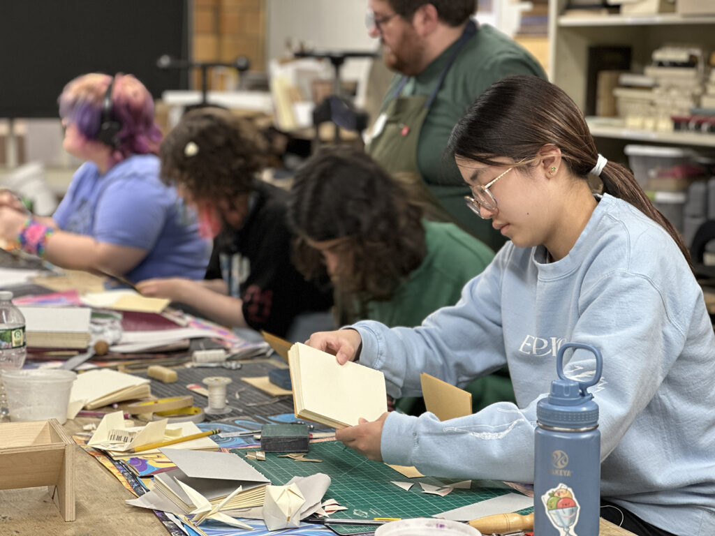 Bookbinding Teen Intensive student sewing books