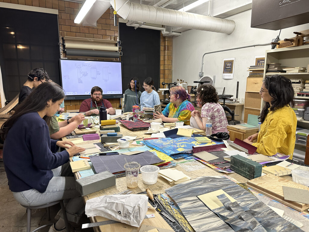 Bookbinding Teen Intensive instructor giving a demo to the students 