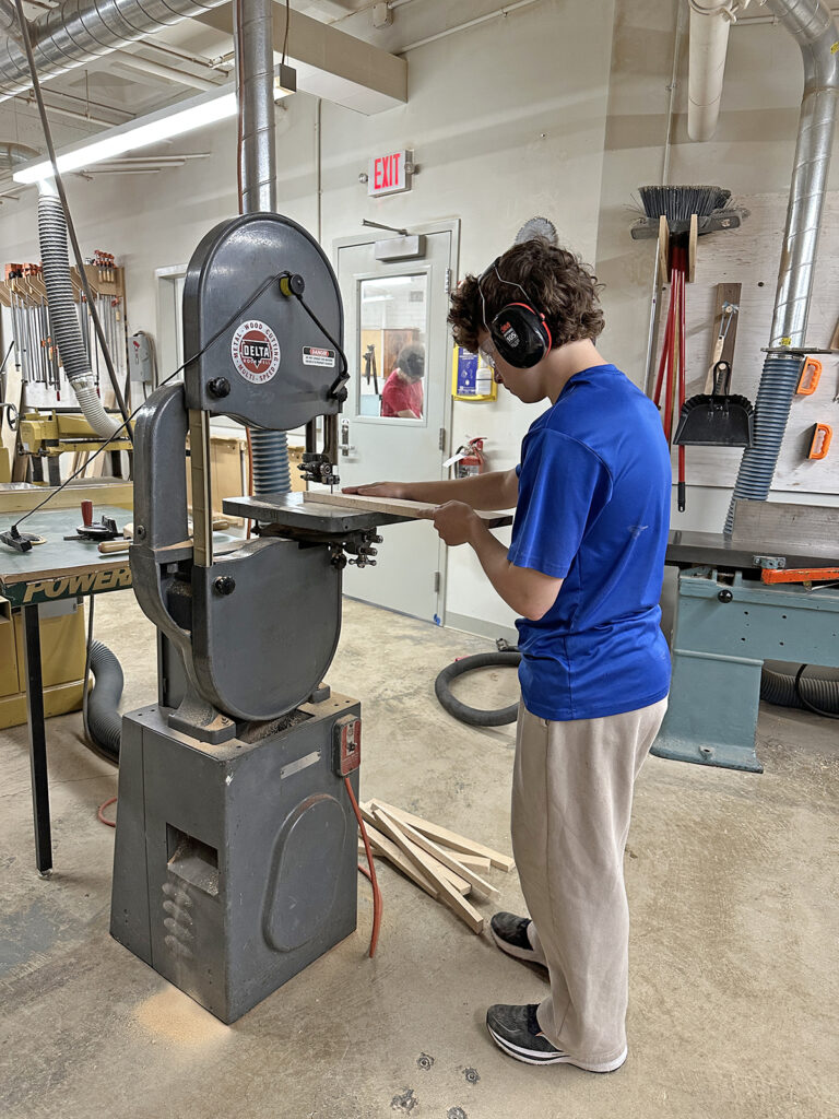 Woodworking Teen Intensive student using the band saw