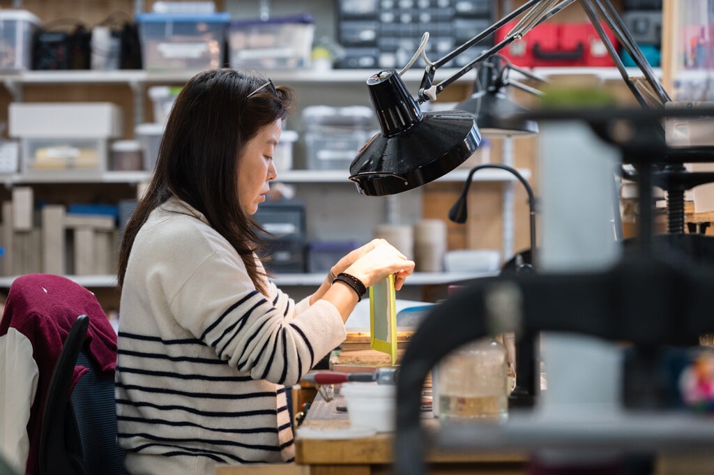 Bookbinding student gluing boards for a book cover