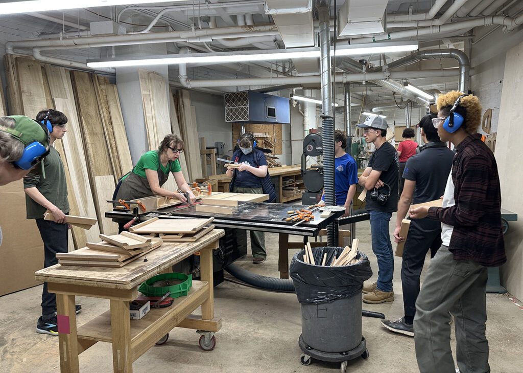 Woodworking intensive instructor Ellen Kaspern leads a demo on the table saw