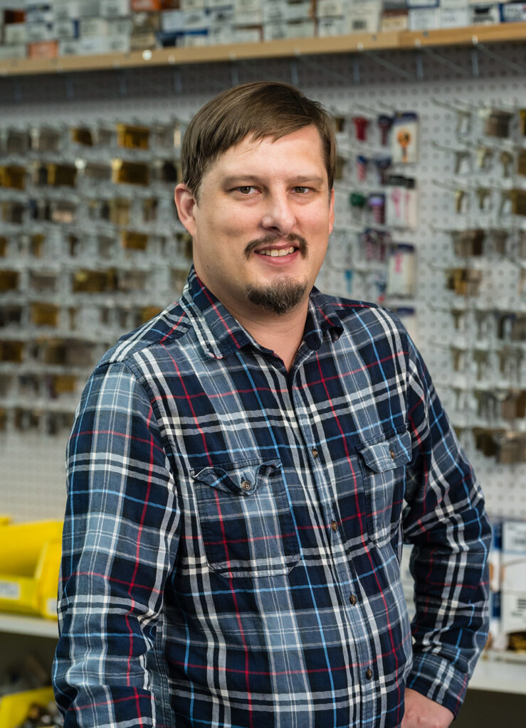 Rick Hendricks standing the Locksmithing classroom