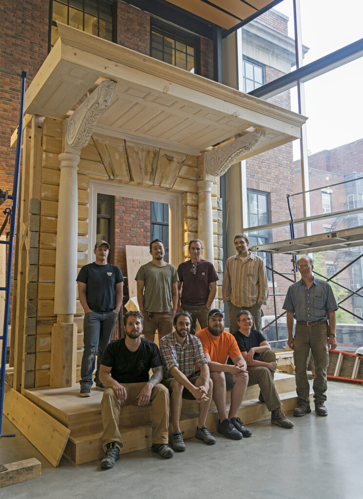 Second-year Preservation Carpentry students in front of the first floor Hancock Door facade recreation in May 2022
