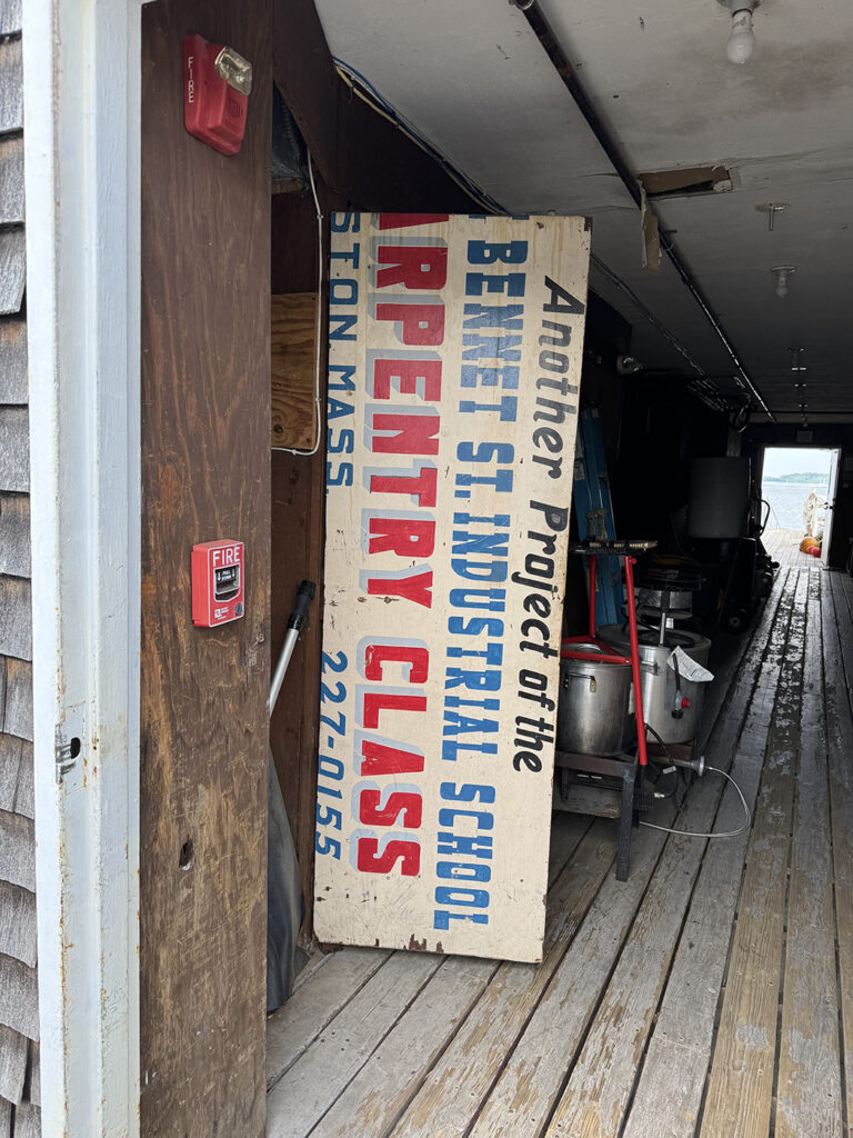 Discovering a Carpentry project sign hidden behind a door at the Squantum Yacht Club
