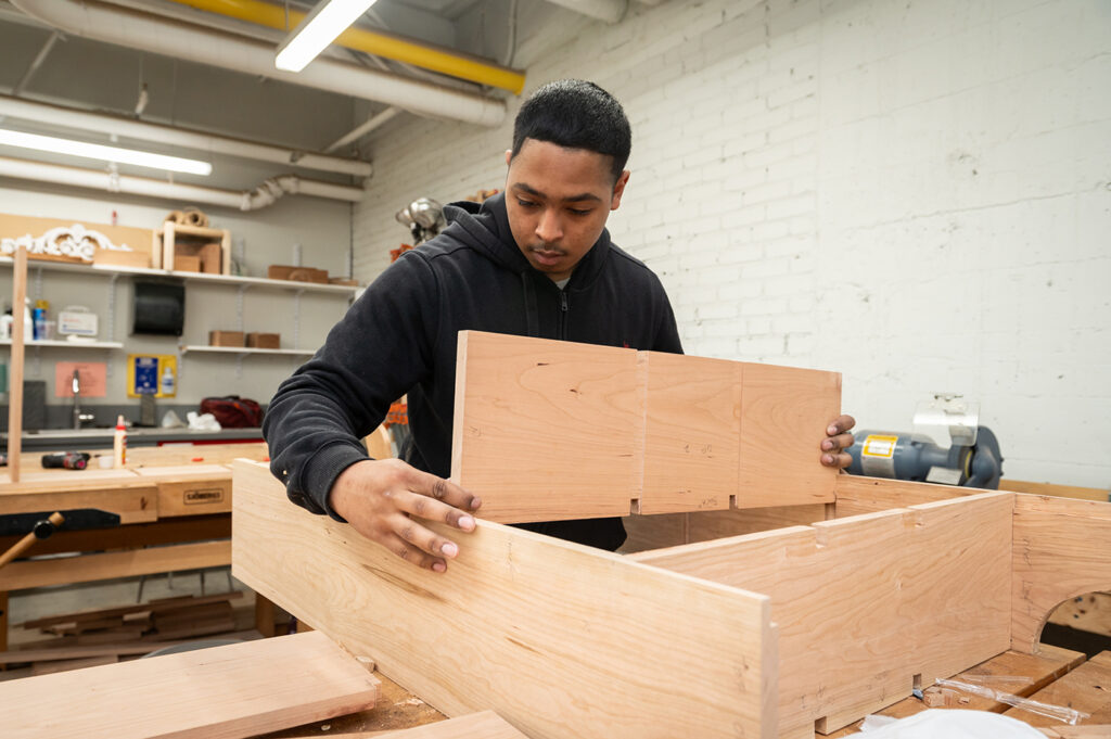 Woodworking Teen Intensive student working on a bookshelf
